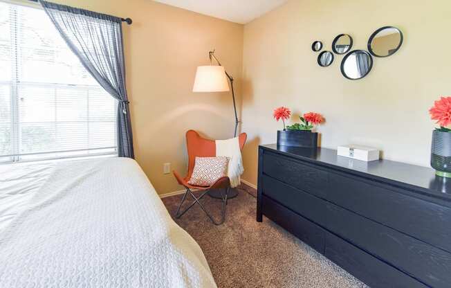 a bedroom with a bed and a dresser  at Riverset Apartments, Memphis