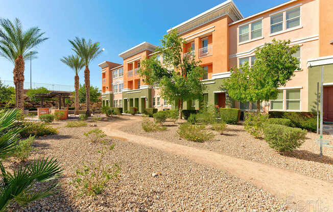 A sunny day at a residential area with apartment buildings and palm trees.