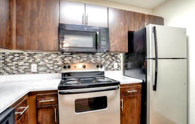 Model kitchen with stainless steel stove and over the range microwave