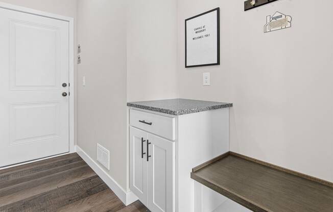 a utility room with a counter and bench in a 555 waverly unit