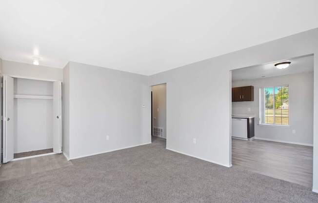 Open-concept living room with dining area and kitchen at Farmbrooke Manor Clinton Township MI