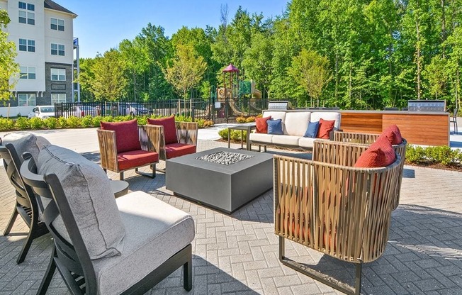 a patio with furniture and a fire pit