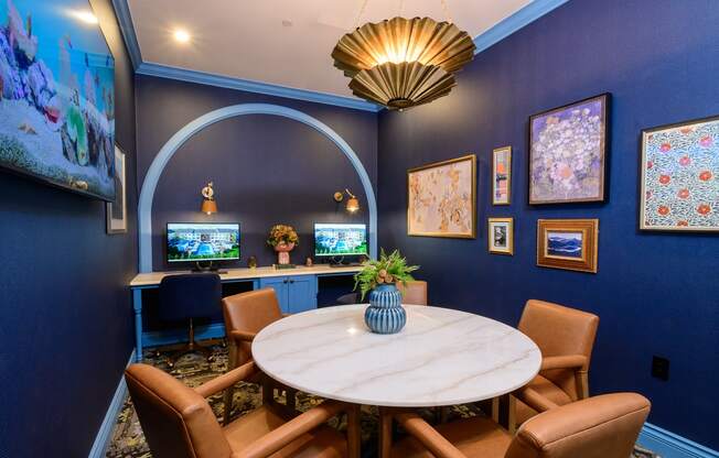 A dining room with a round table and chairs.