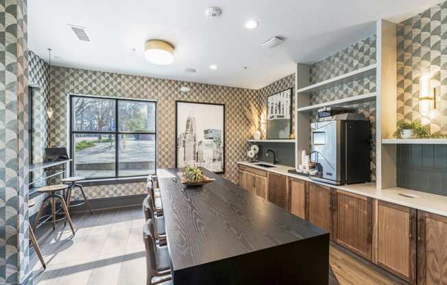 a kitchen with a long wooden table and a large window