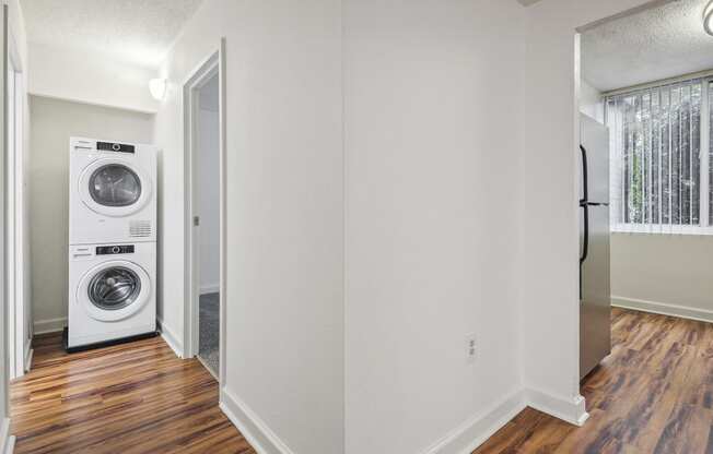 an empty room with a washing machine and a dryer in it