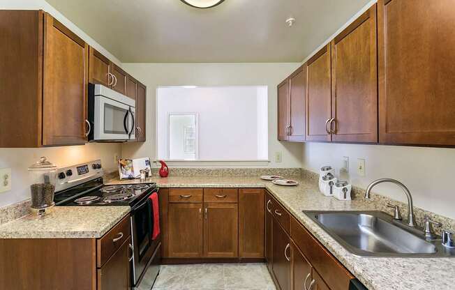 Kitchen with cabinets at The Apartments at Owings Run, Maryland, 21117