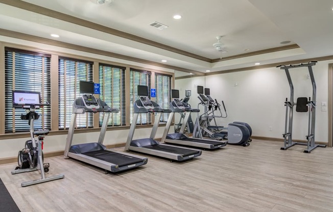 Treadmills and bicycle machines inside resident fitness center