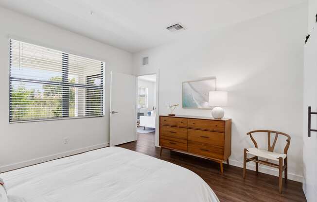 a bedroom with a bed and a dresser and a window at Odyssey, Florida