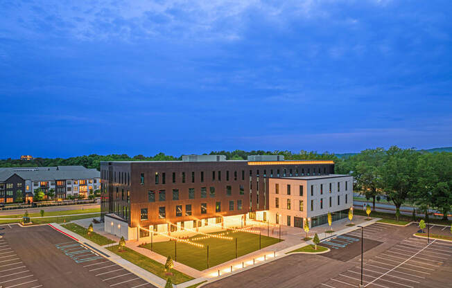 an aerial view of a building at night with lights