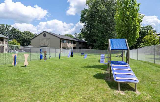 a playground with a swing set and a tennis court