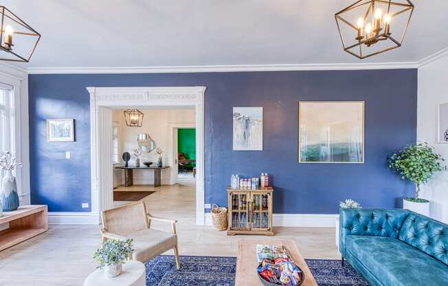 a living room with blue walls and a blue couch