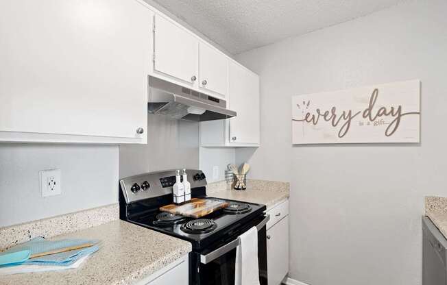 A kitchen with a stove top oven and a sign that says "every day".
