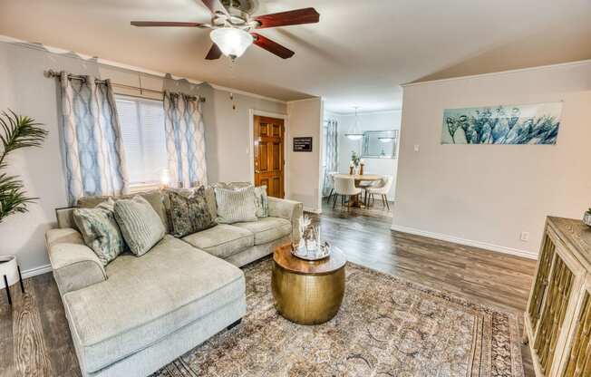 a living room with a couch and a ceiling fan