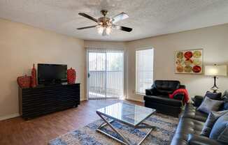 a living room with leather furniture and a glass coffee table