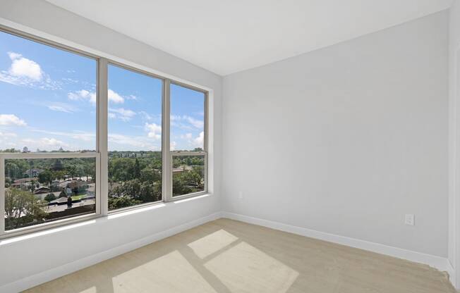 a room with white and blue wallpapers and a window