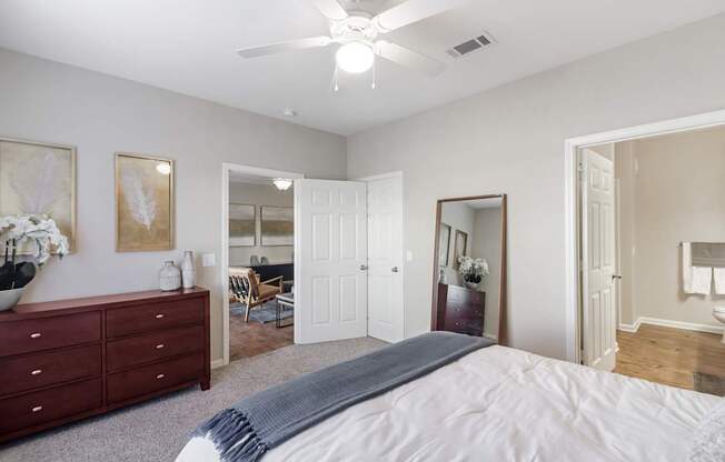 a bedroom with a large bed and a ceiling fan at Cumberland Place Apartment Homes, Tyler 75703