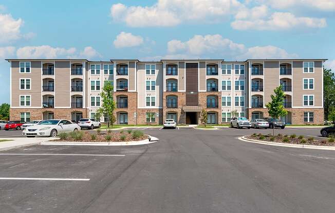 an empty parking lot in front of an apartment building