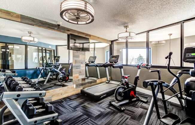 a gym with cardio machines and other exercise equipment  at ReNew at Neill Lake, Eden Prairie, 55344