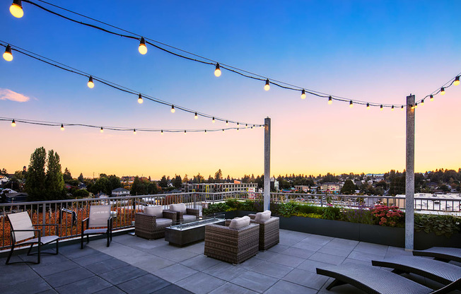 Studios In Greenwood, WA - The Morrow - Outdoor Rooftop Deck With Cozy Seating, Hanging Lights, Beautiful Views, And Fireplace