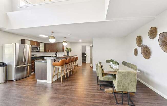 A modern kitchen with a dining area and a large island.