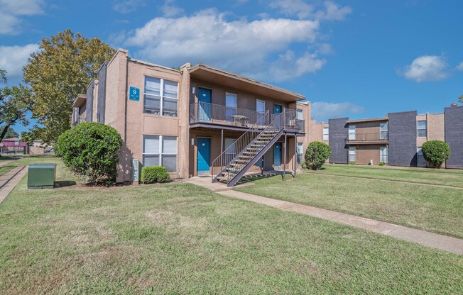 Apartment complex with a blue sky and clouds in the background at The Drake in Bossier City, LA