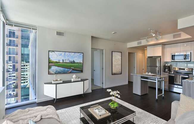 A modern living room with a large flat screen TV mounted on the wall.
