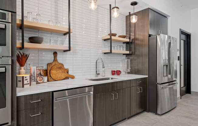 a kitchen with gray cabinets and white countertops at The Lodge at Overland, Minnesota