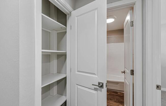 A white door is open to a hallway.