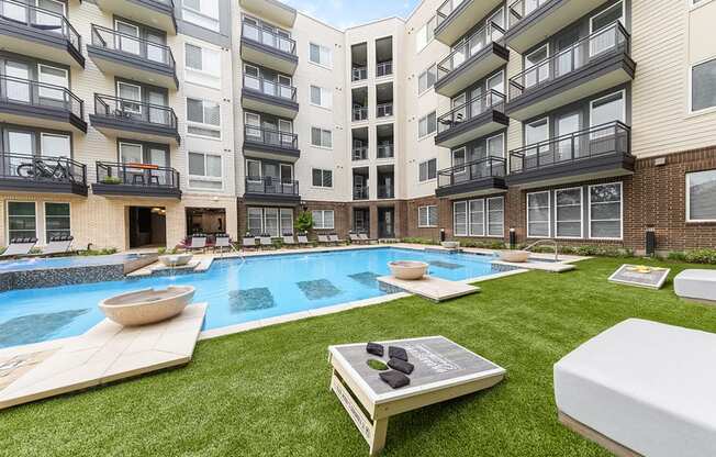 an apartment building with a pool in the middle of it
