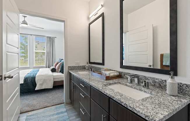 A bathroom with a large mirror above a sink.