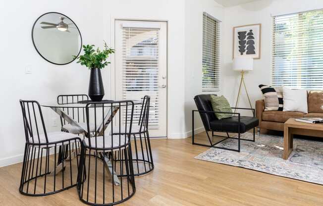 Living room and dining area with ceiling fan and balcony door