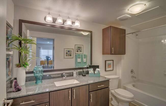 A bathroom with a sink, toilet, and bathtub.