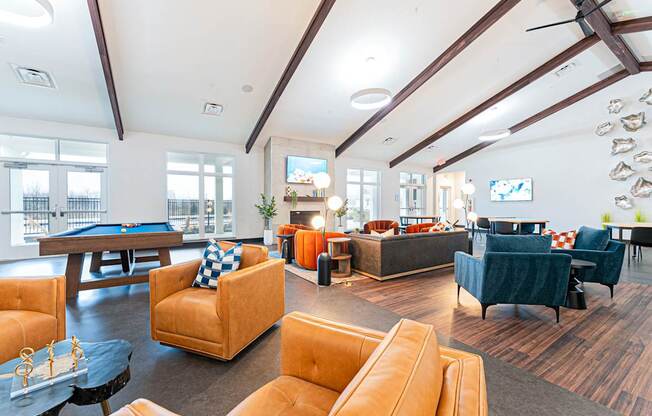 A large room with a pool table and a television.