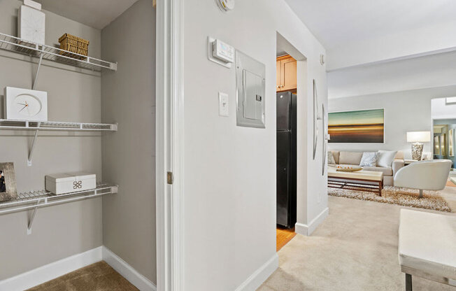 a living room with a door to a closet