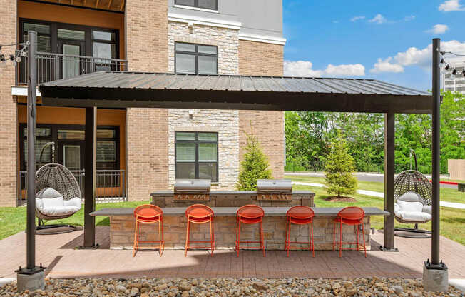 A patio with a table and chairs under a roof.