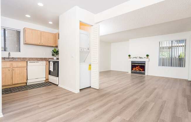 Livingroom and kitchen with in unit washer and dryer at Woodbend, Alta Loma, California