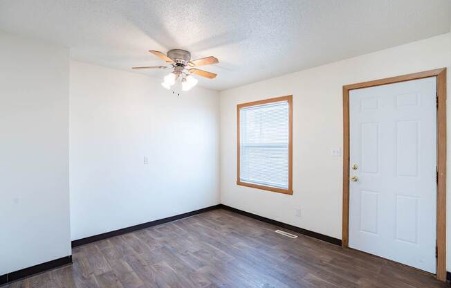 A room with a ceiling fan and a door. West Fargo, ND Sheyenne Terrace Townhomes