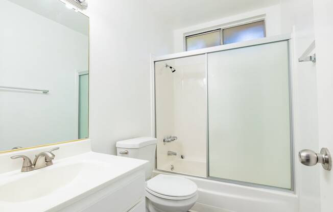 a bathroom with a sink toilet and a shower