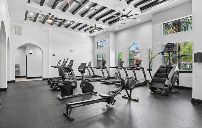 A gym with treadmills and elliptical machines.