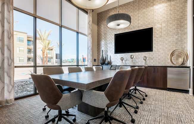 A conference room with a large table and chairs.