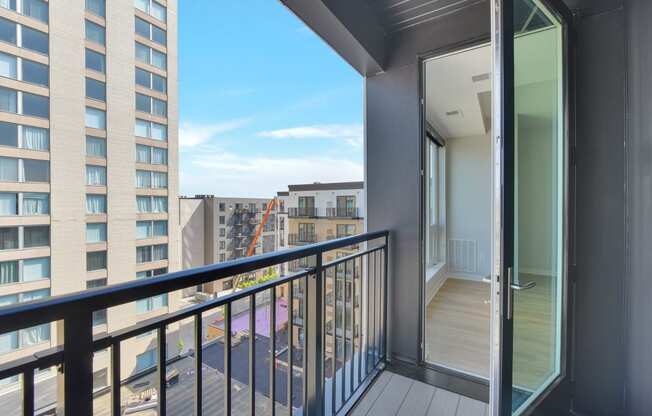 a balcony with a door and a view of the city