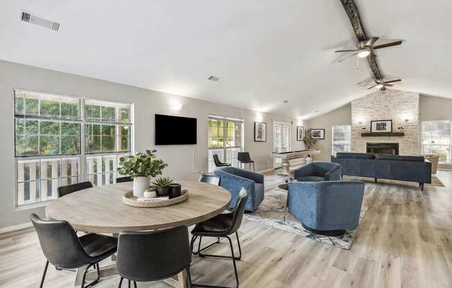 A modern living room with a round table and chairs.
