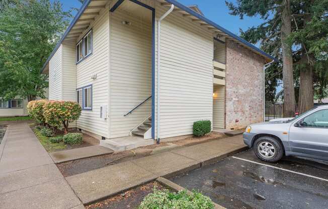 a white house with a car parked in front of it