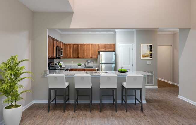 a kitchen with a large island with white chairs