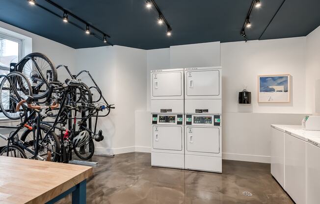 a kitchen with a bunch of bikes on the wall