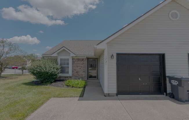 a white house with a driveway and a garage door