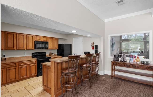 a kitchen with a large island and a breakfast bar at Millcreek Woods Apartments, Olathe, Kansas
