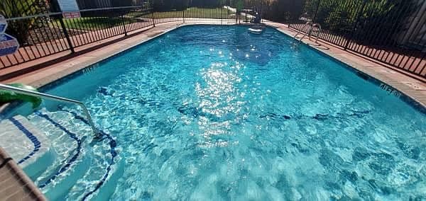 a large swimming pool with a fence around it