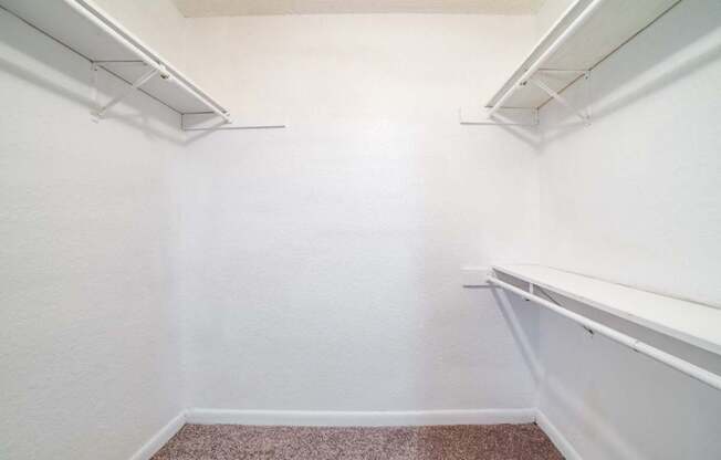 A white wall with a brown carpet.