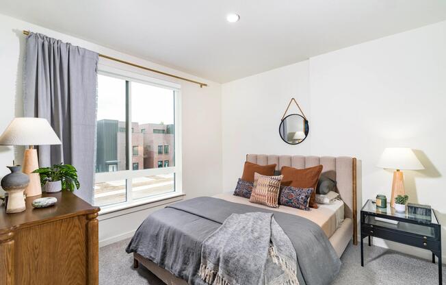 A serene bedroom retreat at Modera University Park, pairing soft finishes and natural light with a location close to University Park’s dining and culture.